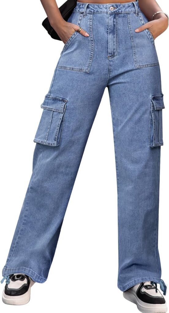 A woman wearing Fly Clothing Co. high-waisted blue denim cargo pants featuring large utility side pockets and front patch pockets.