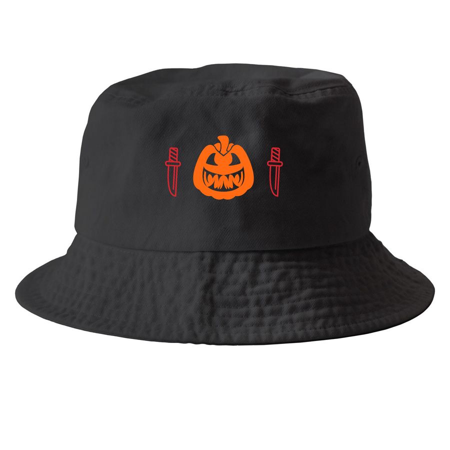 "Studio shot of the Pumpkin Slice Bucket Hat by FLY Clothing Co. The hat is black with a central graphic featuring a sinister orange jack-o'-lantern face flanked by two vertical knife outlines on the front, set against a white background."