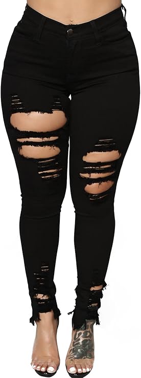 A pair of high-waisted black skinny jeans featuring heavy distressing with large horizontal rips across the thighs and smaller shredded details near the frayed, raw-edge ankles.