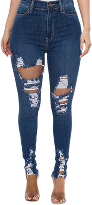 A pair of high-waisted, dark-wash blue skinny jeans featuring significant horizontal distressing and large rips at the knees and thighs. The jeans have a frayed, raw-edge hem at the ankles.