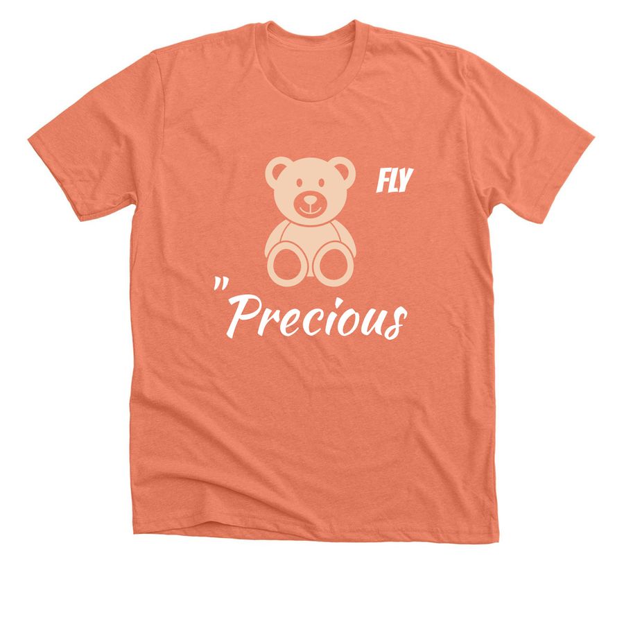A peach-colored, short-sleeved unisex t-shirt featuring a centered graphic of a tan teddy bear. To the right of the bear is the word "FLY" in a bold white font, and below it is the word "Precious" in white cursive script.