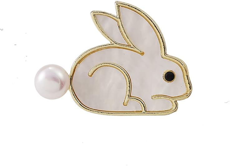 A whimsical bunny-shaped brooch pin featuring a gold-tone metallic outline, a white pearlescent body, a small black eye, and a round white pearl for the tail.