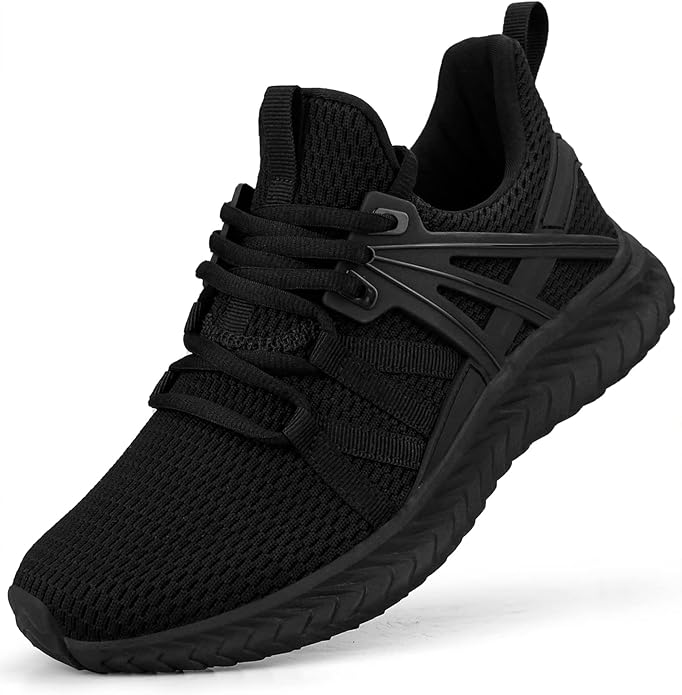 A pair of low-profile black slip-on sneakers with a white rubber platform sole. The shoes feature elastic side goring for a flexible fit and a minimalist design, shown against a neutral studio background.