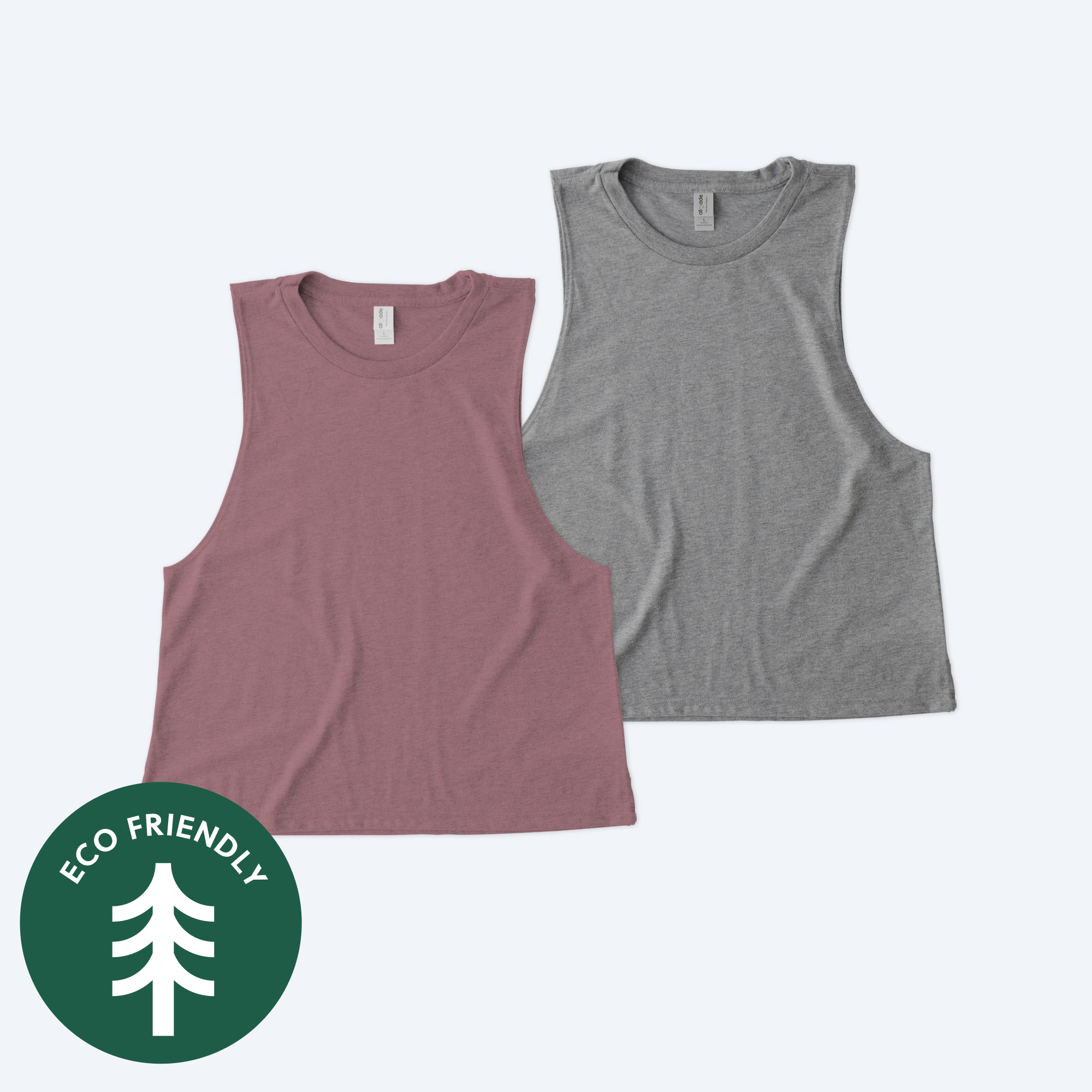 Two blank Allmade Eco Triblend women’s muscle tanks in dusty mauve and heather grey, featuring a sustainable eco-friendly badge for custom design services.