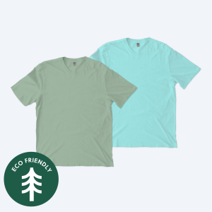 Two blank Allmade organic cotton mineral dye t-shirts, one in a muted sage green and one in a vibrant aqua blue, displayed on a clean white background with a green "Eco Friendly" tree icon for custom apparel design services.