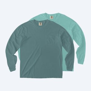 Two blank Comfort Colors heavyweight long sleeve pocket t-shirts in seafoam green and blue-grey, featuring a relaxed fit and a single chest pocket for custom design services.