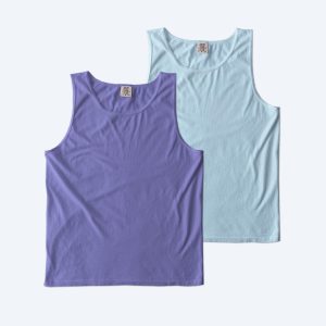 Two blank Comfort Colors garment-dyed tank tops, one in violet and one in light blue, featuring a soft-washed vintage finish for custom apparel design services.