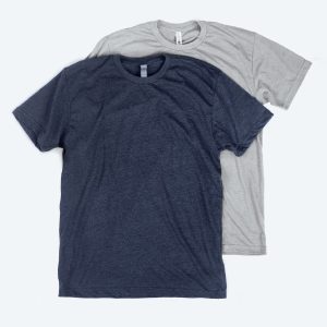 Two blank premium unisex t-shirts in heathered navy blue and light heather grey, featuring a modern retail fit and displayed on a clean white background for custom apparel design services.