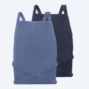 Two folded, premium recycled denim bib aprons—one in a light blue wash and one in deep indigo—featuring metal adjustment buckles on the neck straps and cross-back style waist ties.