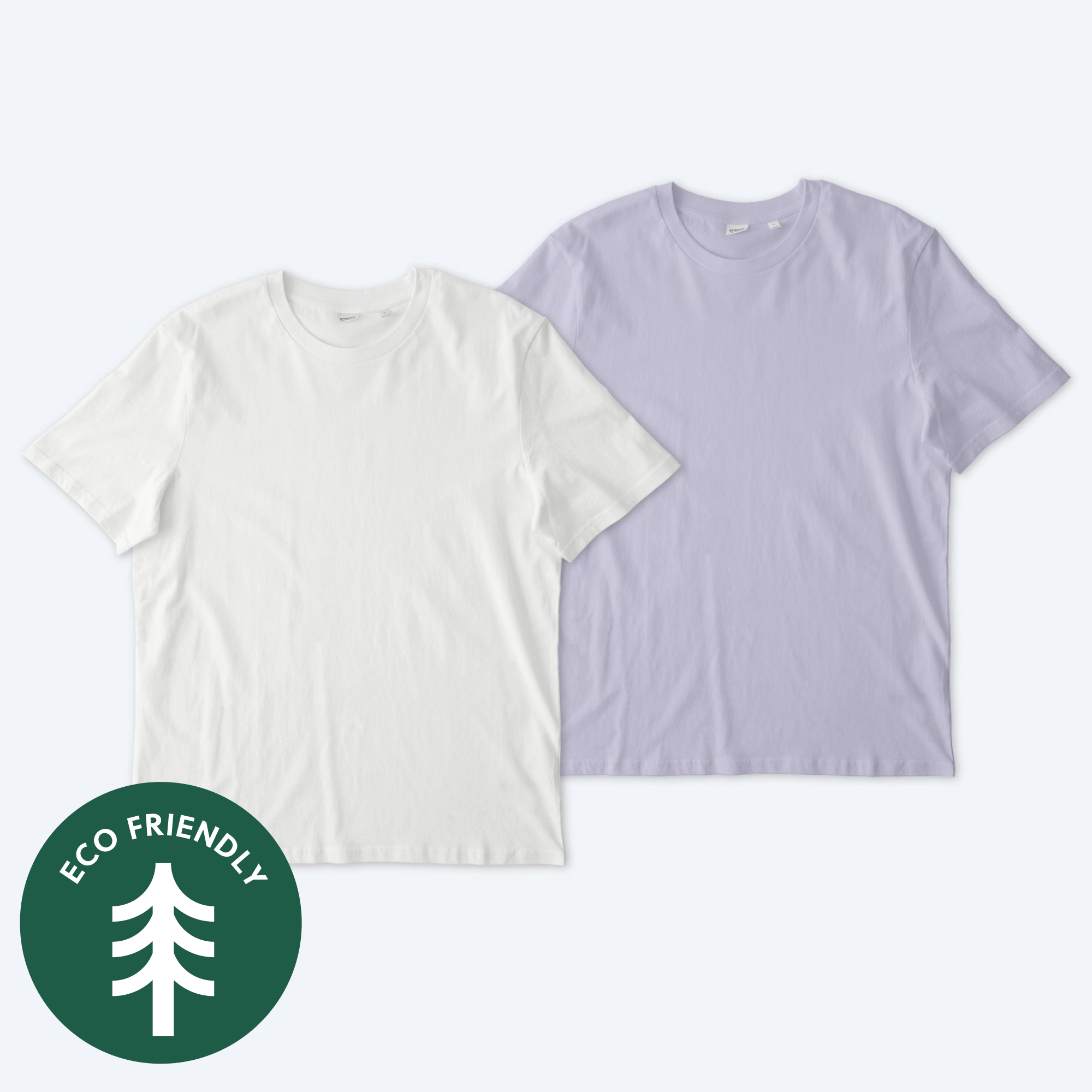 Two blank Stanley Stella unisex Creator 2.0 t-shirts, one in a clean optic white and one in a soft lavender purple, displayed on a neutral background with a green "Eco Friendly" tree icon for custom apparel design services.