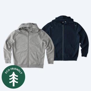 Two eco-friendly custom Stanley/Stella Unisex Cultivator 2.0 Zip Up Hoodies in heather grey and deep navy blue, featuring an "Eco-Friendly" seal, part of the Fly Clothing Co design service in LA and NYC.
