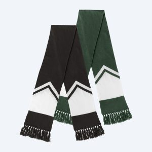 Two custom knit gameday scarves—one in LA black and white, the other in NYC forest green—featuring a bold chevron mountain peak design and fringed edges, perfect for coastal or city winters.