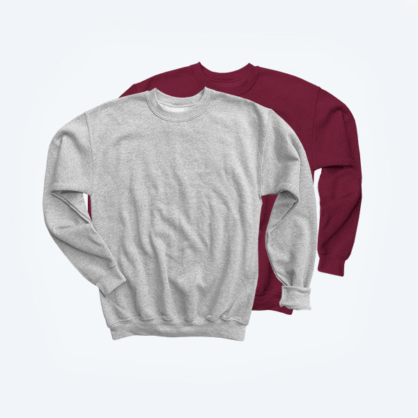 Two blank youth crewneck sweatshirts layered together, featuring one in a classic heather grey and the other in a deep maroon burgundy, highlighting the soft cotton-fleece texture and ribbed collar for custom streetwear branding.