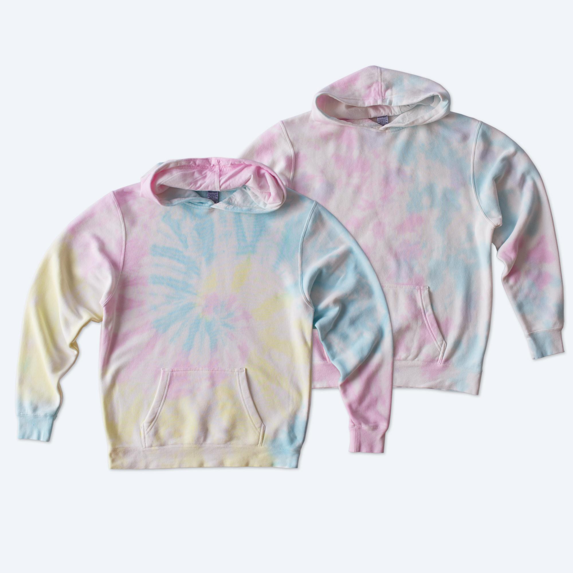 Two custom Youth Tie Dye Pullover Hoodies by Fly Clothing Co featuring a pastel swirl pattern of pink, blue, and yellow with front kangaroo pockets, designed for trendy youth in LA and NYC.