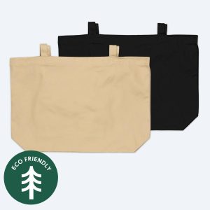 Two blank large organic cotton tote bags, one in natural tan and one in classic black, displayed on a clean white background with a green "Eco Friendly" tree icon for custom branding design services.