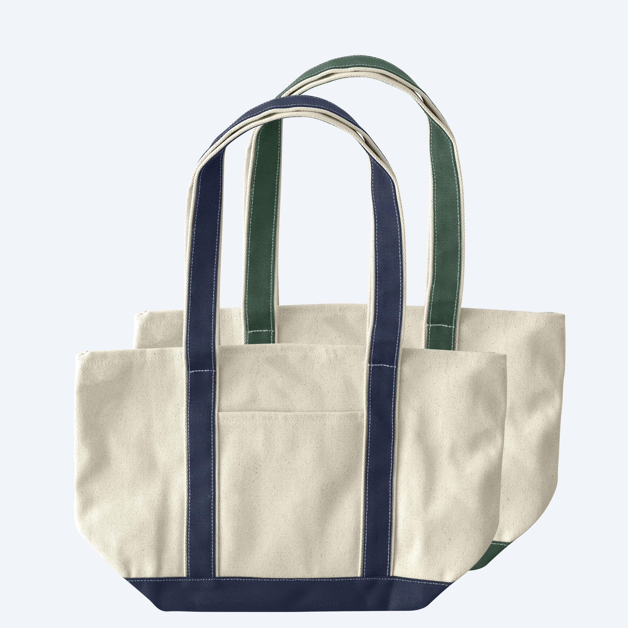 Two large custom two-tone canvas tote bags with contrast straps, featuring spacious structured bases and open tops, displayed on a clean white background for branding design services.