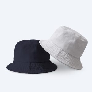 Two blank custom bucket hats, one in washed mustard yellow and one in distressed navy blue, displayed in a relaxed stack on a clean white background for custom design services.