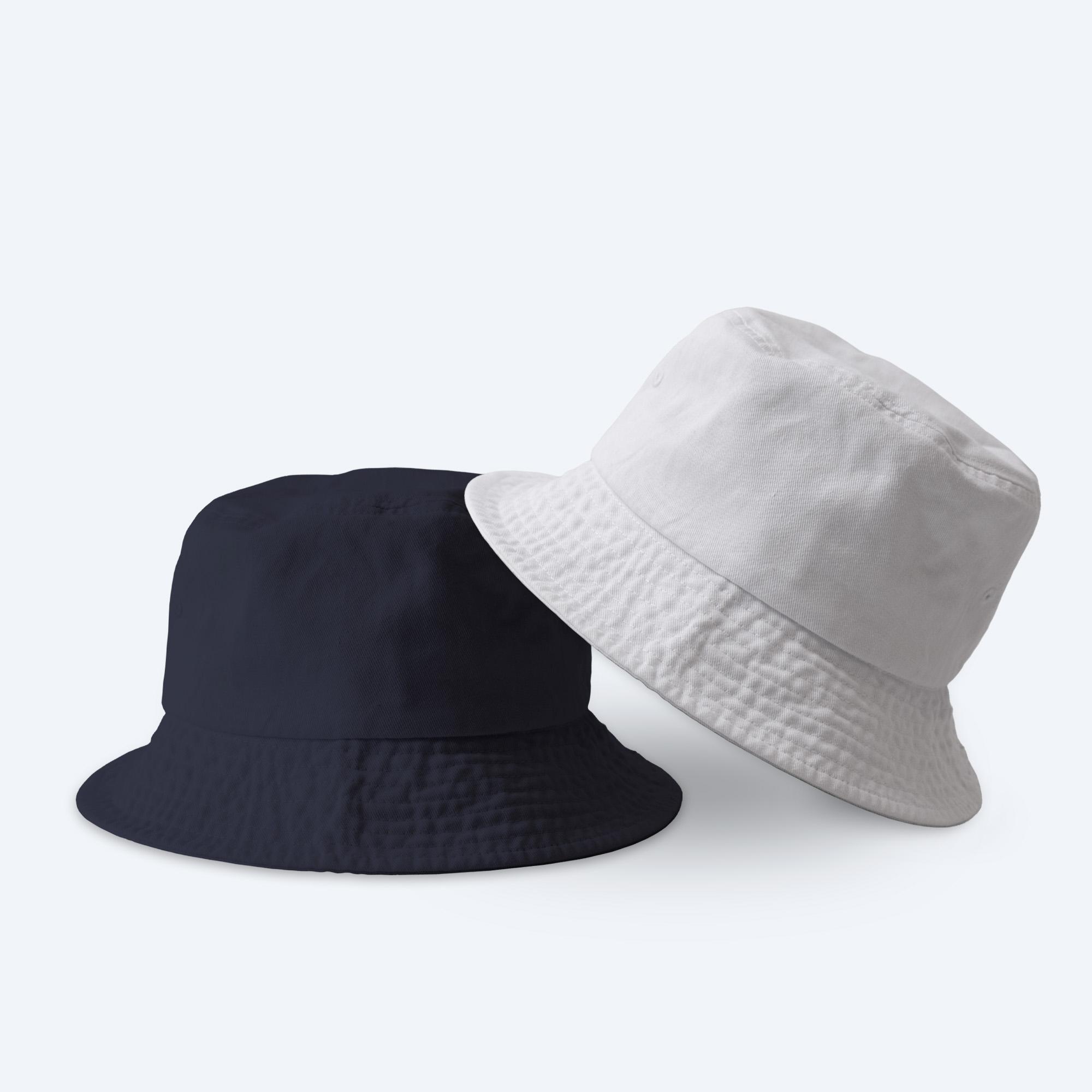 Two blank custom bucket hats, one in washed mustard yellow and one in distressed navy blue, displayed in a relaxed stack on a clean white background for custom design services.