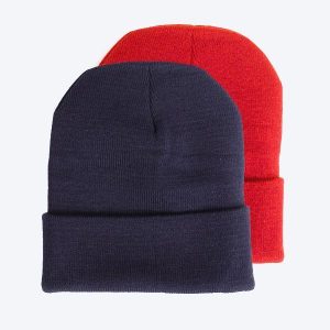 Two blank custom cuffed beanies, one in classic dark navy blue and one in vibrant red, displayed on a clean white background for custom branding design services.