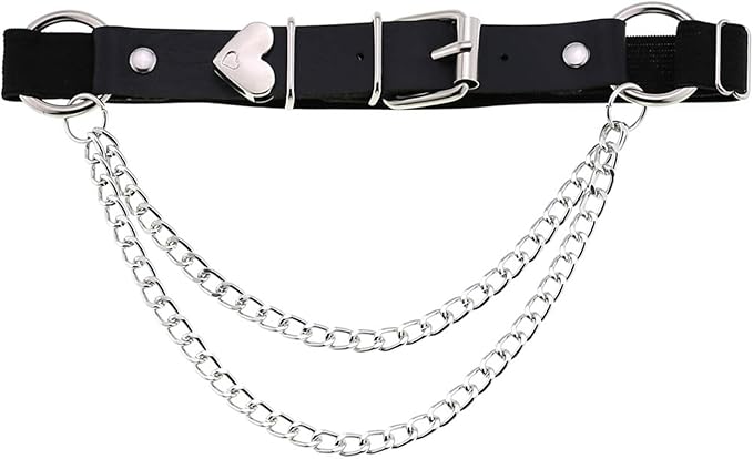 The sleek black leather and dual silver chains add a fierce, alternative vibe that perfectly balances the playful, unapologetic Y2K energy of the bright pink custom tee and sparkling cowboy boots.